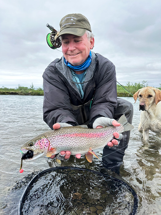 rainbow trout and a fine dog on stream