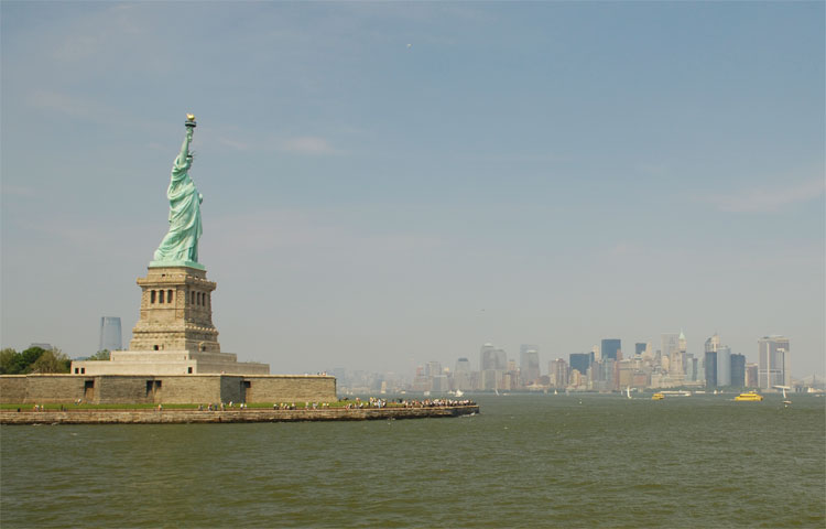 view of the statue of Liberty and Manhattan in the background