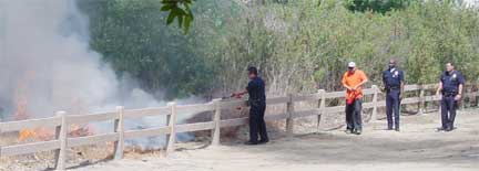 police officer empties his fire extinguisher